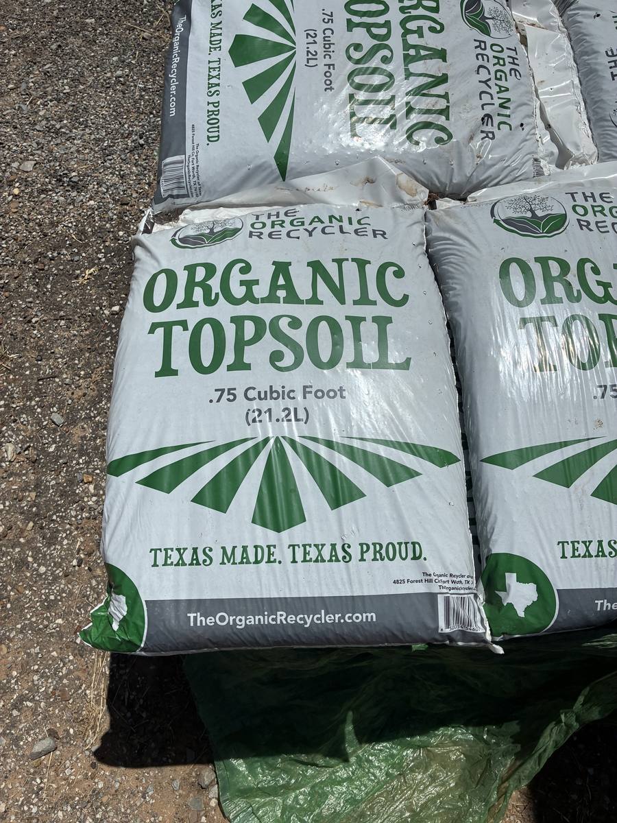 Bags of organic topsoil stacked at the store
